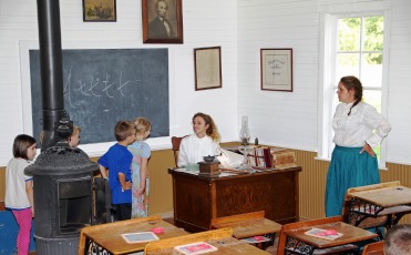 Children talking to the school teachers in the one-room schoolhouse at Ushers Ferry Historic Village